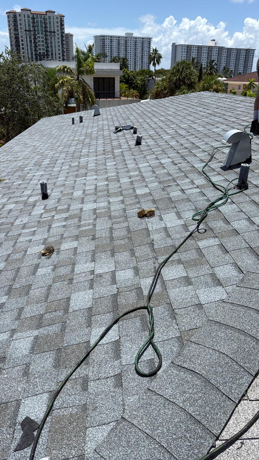 Completed architectural shingle roof overlooking Fort Lauderdale high-rises