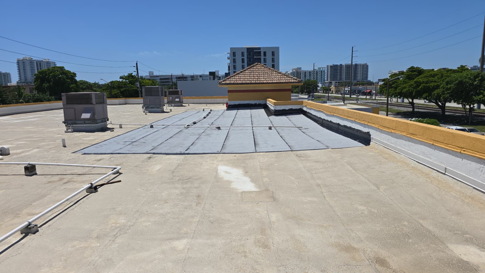 Modified bitumen membrane installation on a Miami commercial building