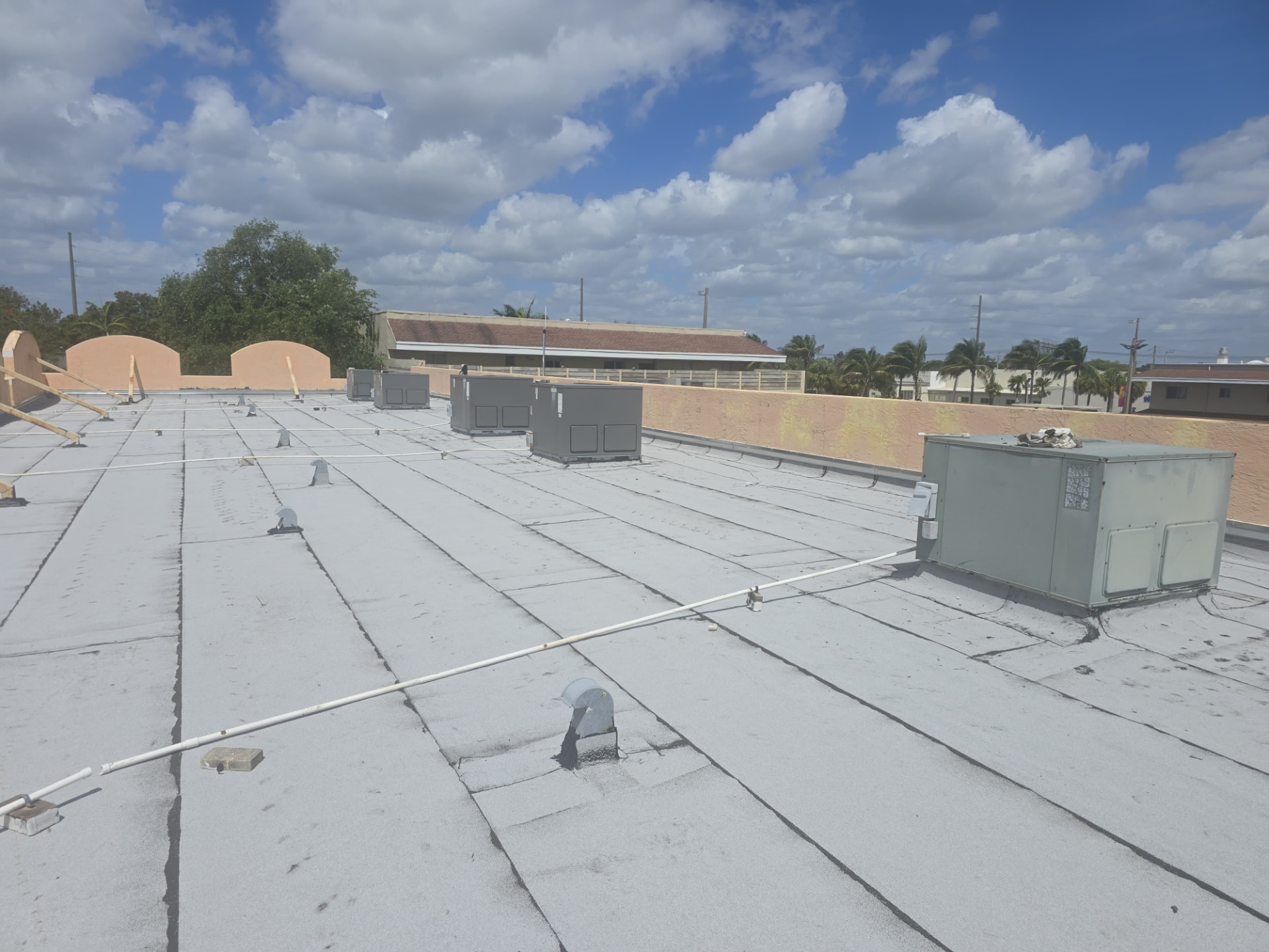 Commercial flat roof rebuilt around rooftop HVAC units in South Florida